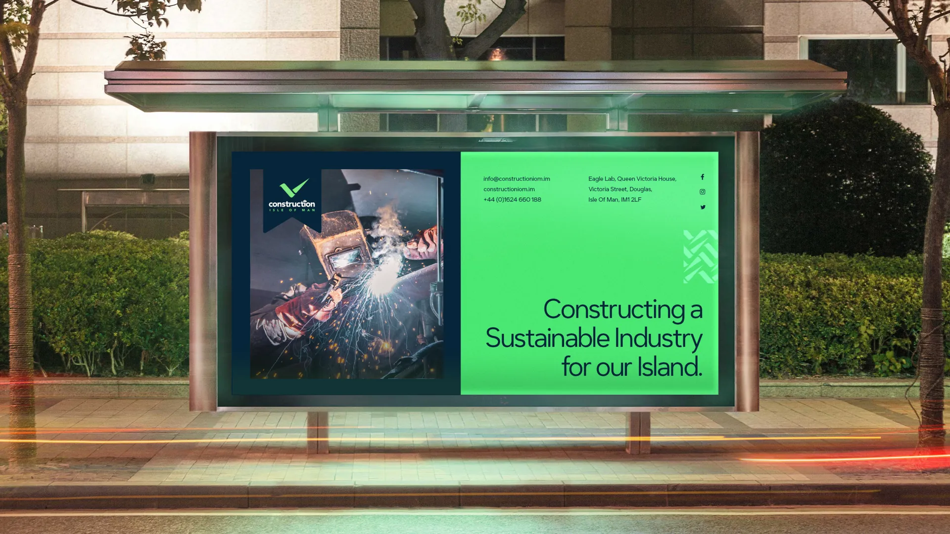 A Construction Isle of Man advertisement displayed in a bus shelter, showing a welding photograph alongside the brand message "Constructing a Sustainable Industry for our Island" and the Construction Isle of Man logo designed by DotPerformance
